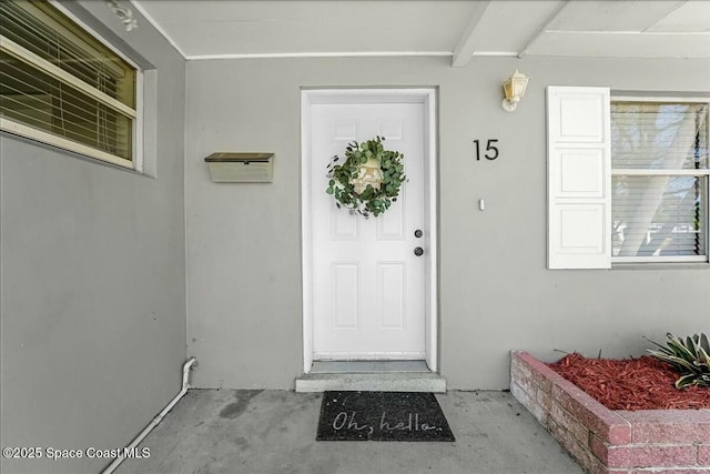 property entrance with stucco siding