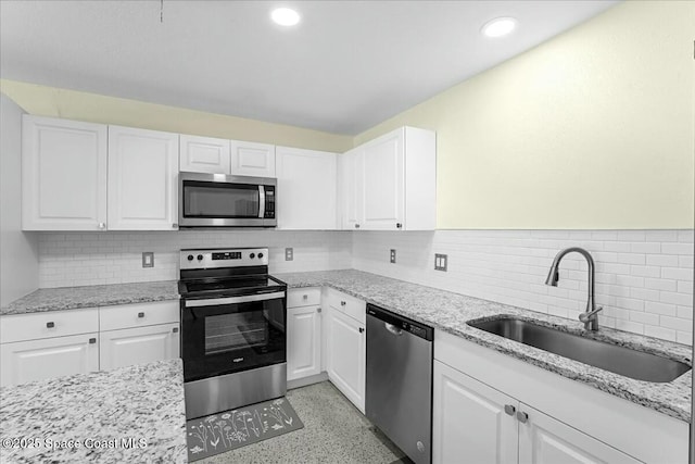 kitchen with white cabinetry, appliances with stainless steel finishes, and a sink