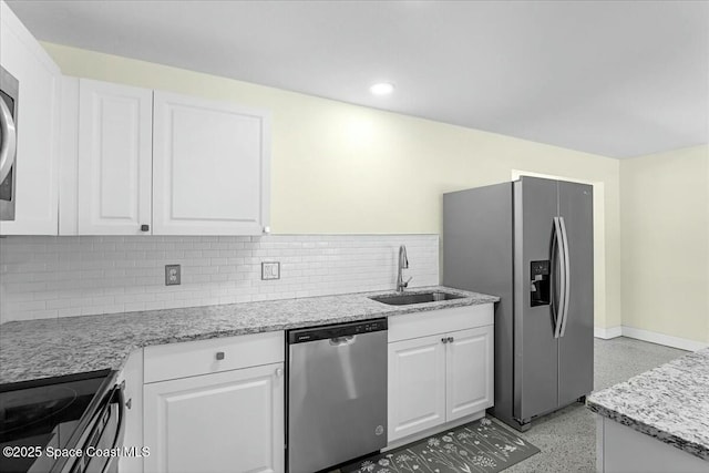 kitchen featuring a sink, stainless steel appliances, light speckled floor, and white cabinets