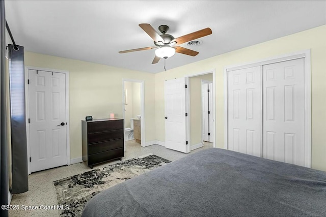 bedroom with visible vents, ensuite bathroom, speckled floor, baseboards, and ceiling fan