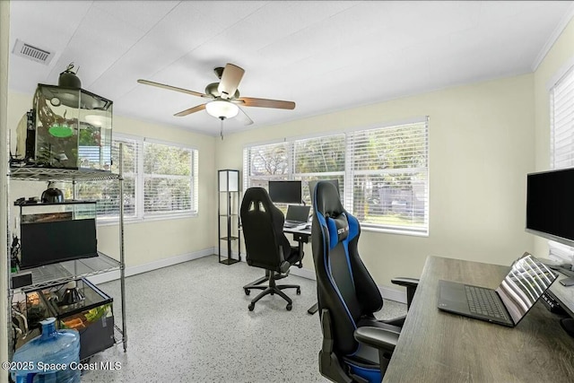 home office featuring visible vents, plenty of natural light, baseboards, and ceiling fan