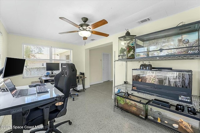 office with visible vents, speckled floor, and ceiling fan