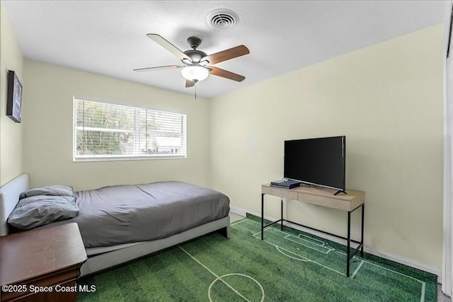 carpeted bedroom with visible vents, baseboards, and ceiling fan