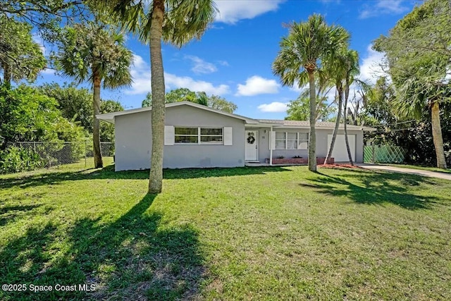 single story home featuring stucco siding, driveway, a front lawn, fence, and an attached garage