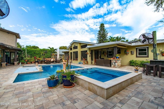 pool with a patio, an in ground hot tub, and outdoor dry bar