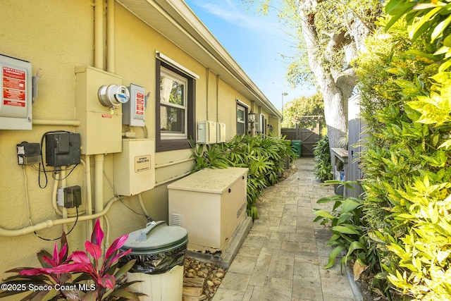 view of home's exterior featuring stucco siding, a patio area, and fence