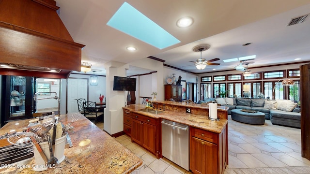 kitchen with a sink, visible vents, stainless steel dishwasher, and a skylight