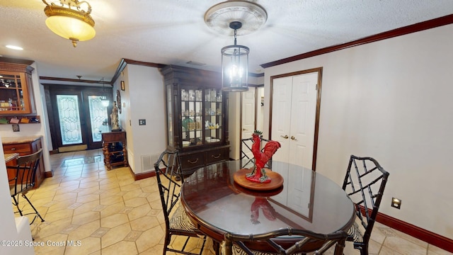 dining area with visible vents, a textured ceiling, light tile patterned flooring, crown molding, and baseboards