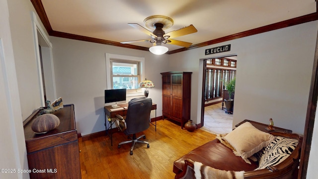 home office featuring baseboards, a ceiling fan, crown molding, and light wood finished floors