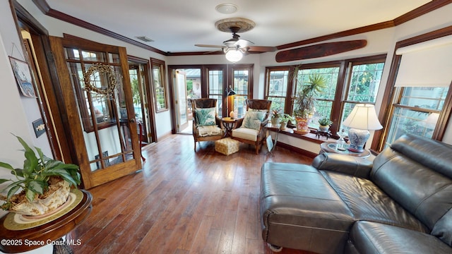 living room with hardwood / wood-style floors, crown molding, french doors, and a wealth of natural light