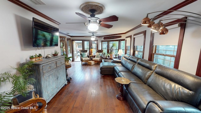 living area with dark wood-style floors, visible vents, crown molding, and ceiling fan