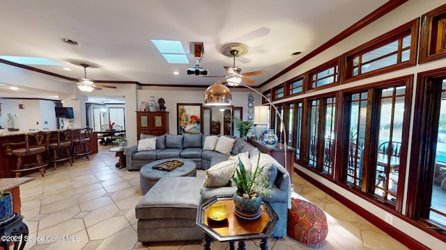 living room featuring recessed lighting, a ceiling fan, a skylight, and crown molding