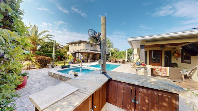 outdoor pool with a gazebo, an in ground hot tub, a ceiling fan, and a patio area