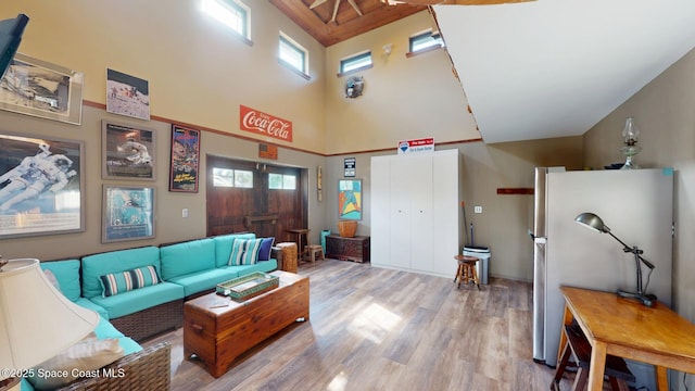 living room featuring a high ceiling and wood finished floors