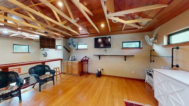 interior space with wooden ceiling, baseboards, light wood finished floors, and beam ceiling