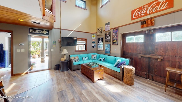 living area featuring plenty of natural light, visible vents, and wood finished floors