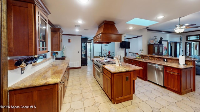 kitchen with a spacious island, recessed lighting, appliances with stainless steel finishes, a skylight, and a sink