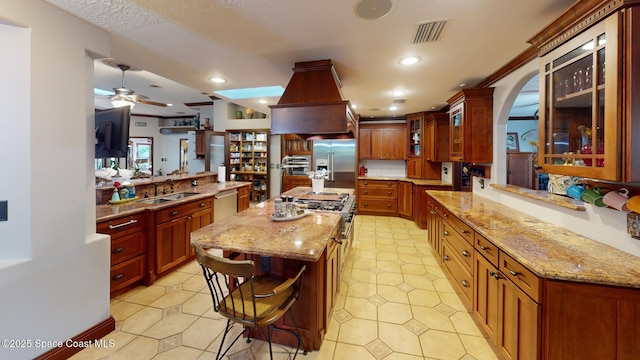 kitchen featuring visible vents, high quality appliances, light stone counters, recessed lighting, and glass insert cabinets