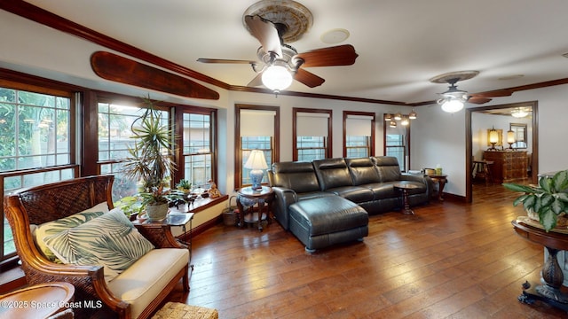 living room featuring ceiling fan, baseboards, ornamental molding, and hardwood / wood-style flooring