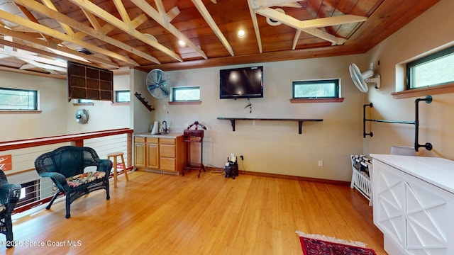 interior space featuring wooden ceiling, plenty of natural light, light wood-style floors, and baseboards