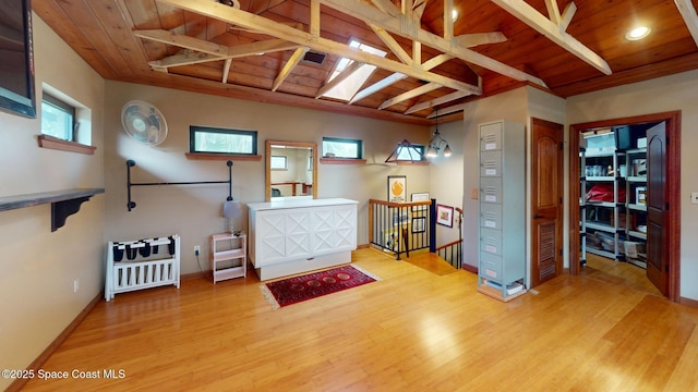 miscellaneous room with baseboards, an upstairs landing, wood ceiling, and wood finished floors