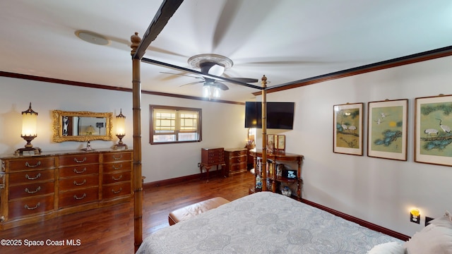 bedroom featuring crown molding, wood finished floors, and baseboards