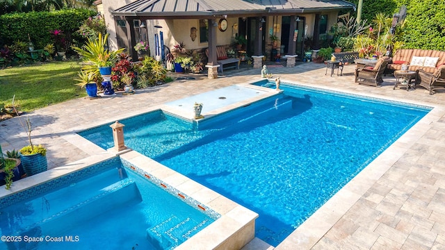 view of swimming pool featuring a patio area, a fenced in pool, and an in ground hot tub