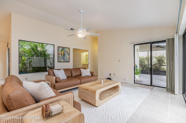 living area with light tile patterned floors, baseboards, a ceiling fan, and vaulted ceiling