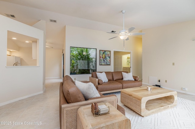 living room featuring light tile patterned floors, baseboards, visible vents, and ceiling fan