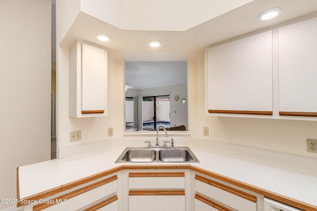 kitchen featuring a sink, white cabinetry, recessed lighting, and light countertops