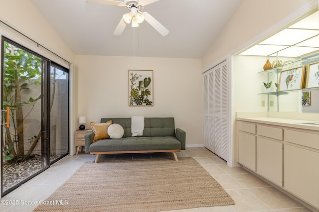 sitting room featuring light tile patterned floors, a ceiling fan, and vaulted ceiling