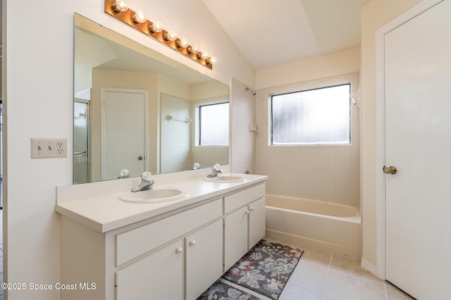 full bathroom with a sink, washtub / shower combination, double vanity, and tile patterned flooring