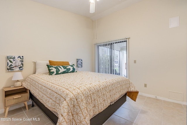 bedroom with light tile patterned floors, baseboards, and high vaulted ceiling