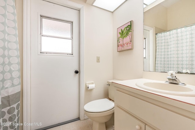 bathroom featuring vanity, tile patterned floors, toilet, and a shower with shower curtain