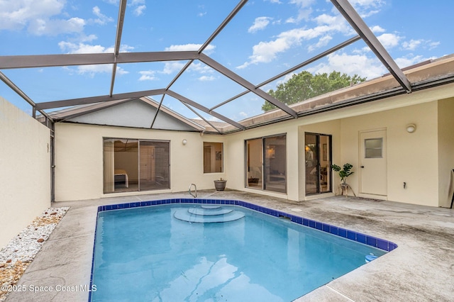 pool with glass enclosure and a patio