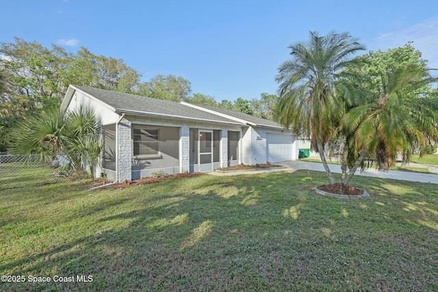 view of front of property featuring fence, an attached garage, a sunroom, concrete driveway, and a front lawn