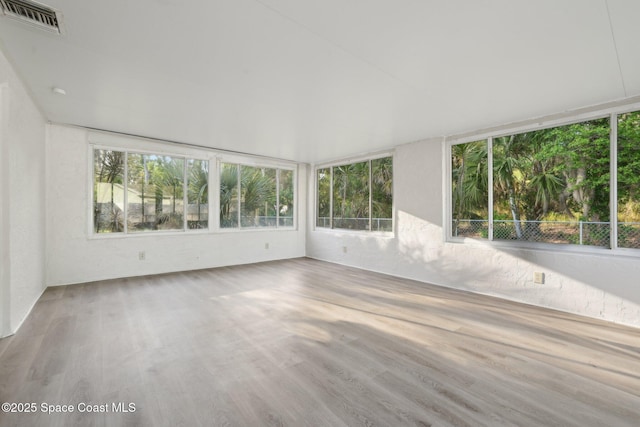 unfurnished sunroom with visible vents