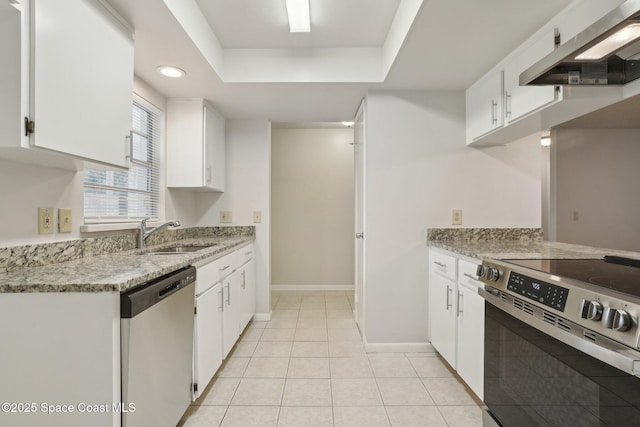 kitchen featuring a sink, range hood, stainless steel appliances, light tile patterned flooring, and white cabinets