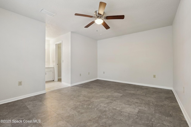 unfurnished room with baseboards, visible vents, and ceiling fan