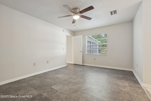 empty room with a ceiling fan, baseboards, visible vents, and a textured ceiling