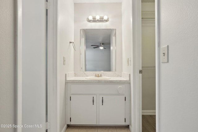 bathroom featuring vanity, a ceiling fan, baseboards, and tile patterned flooring