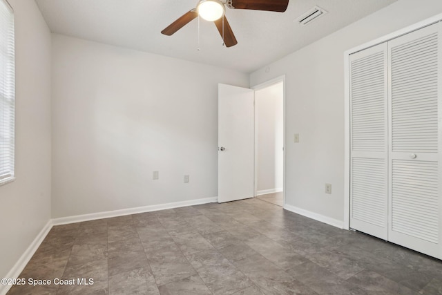 unfurnished bedroom with visible vents, baseboards, a closet, and a ceiling fan