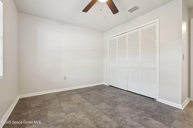 unfurnished bedroom featuring a closet, visible vents, and baseboards