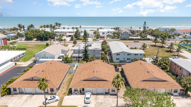 drone / aerial view featuring a residential view and a water view