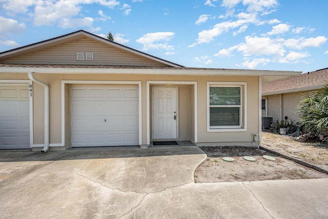 single story home with a garage and driveway