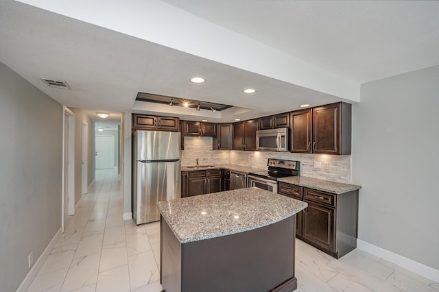 kitchen featuring decorative backsplash, marble finish floor, and stainless steel appliances