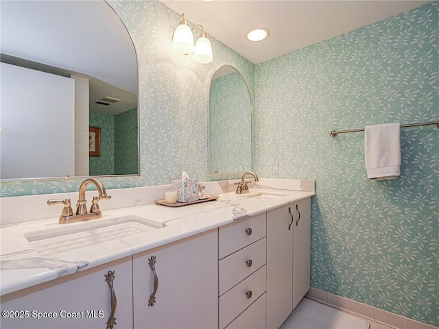 full bathroom with tile patterned floors, visible vents, wallpapered walls, and a sink