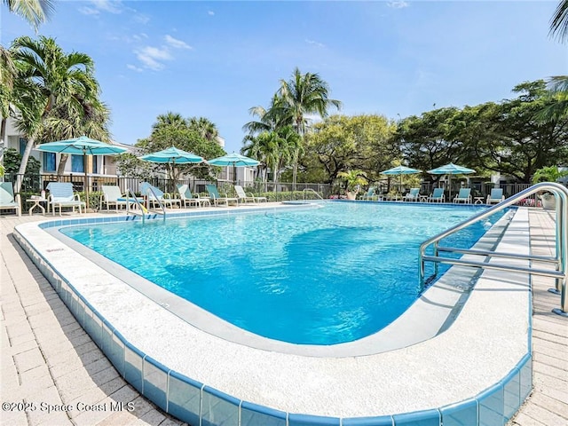 pool featuring a patio and fence