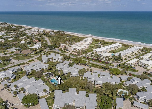 birds eye view of property with a residential view, a water view, and a view of the beach