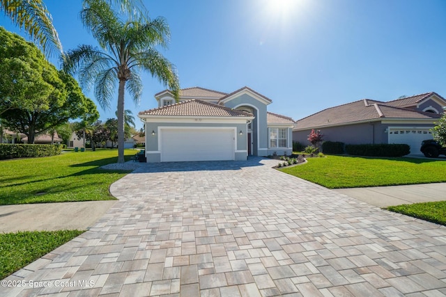 view of front of property featuring stucco siding, an attached garage, decorative driveway, and a front yard